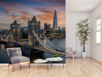 Aerial view to the illuminated Tower Bridge and skyline of London, UK, just after sunset